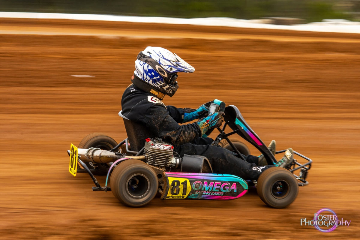 Number 81 Omega kart racing on a dirt track